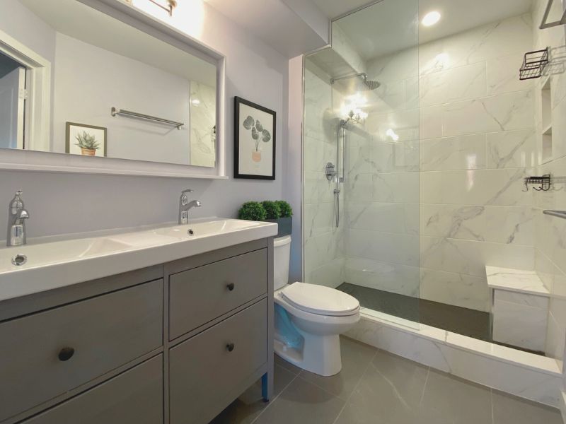 complete bathroom renovation double niche built in shower bench porcelain tile toronto vanity mirror with shelf ikea hemnes vanity Adept Services Contractor GTA Toronto Oakville