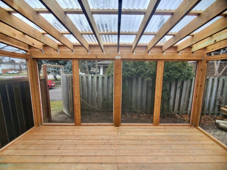 Screened in porch / deck with clear Suntuf polycarbonate roof panels.